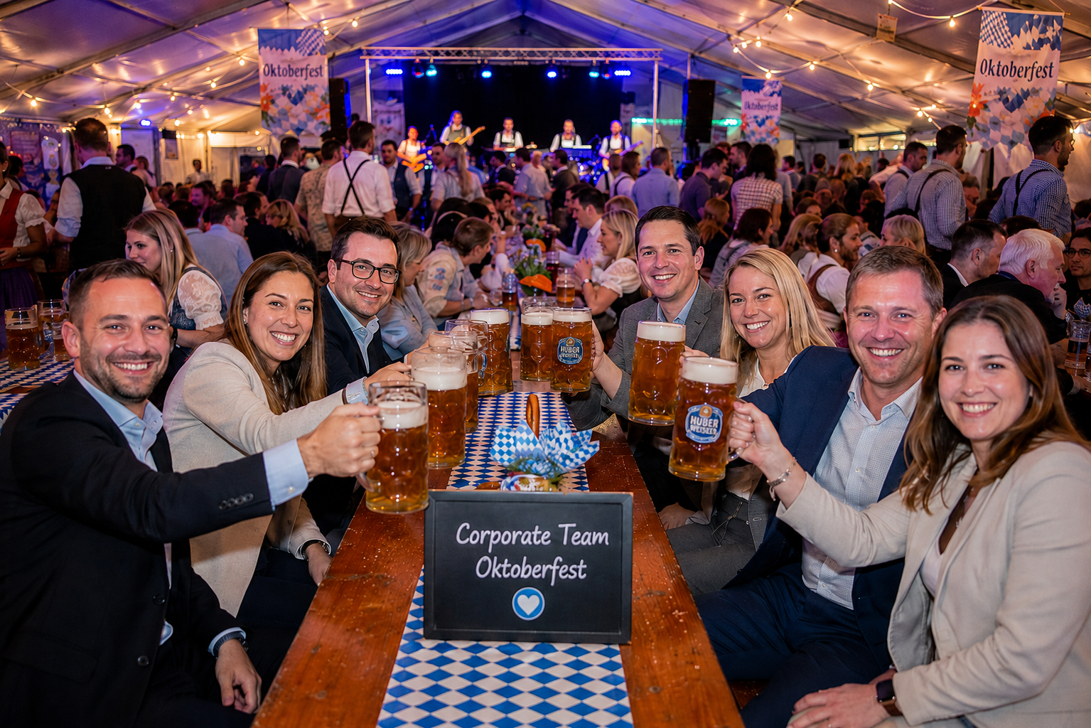 Corporate team raising beers together at Oktoberfest